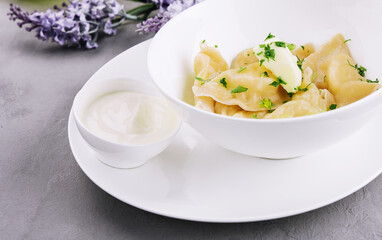 Delicious cooked dumplings and sour cream