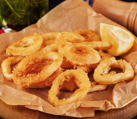 Oven baked breaded calamari rings served with lemon
