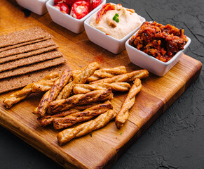 Tasty Assorted Dips on wooden tray