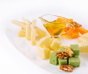 Cheese Platter with Honey, Nuts on white plate