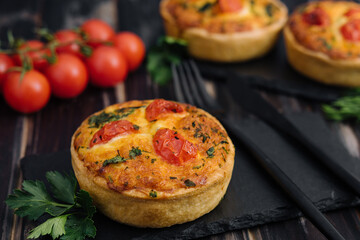 Cheddar cheese and spring onion omelette tarts served on wooden board