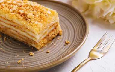 Napoleon cake on plate on table close-up