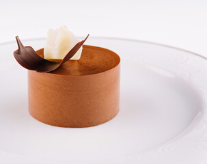 Plate with coffee panna cotta on white