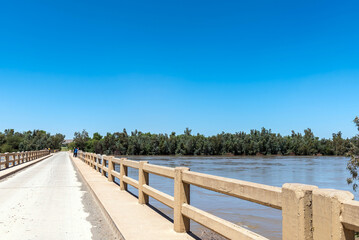Fototapeta na wymiar Road bridge over a flooded Orange River at Grootdrink