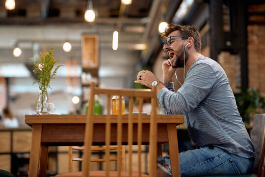 man in the moment enjoy music and drinking coffee