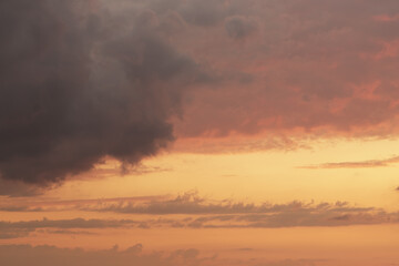 Soft clouds with orange light during summer sunset