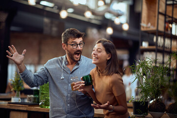 Young hipster man and woman in the bar having a great time and talking.