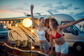 Two young sexy female friends are enjoying their vacation in the camp in the nature. Vacation, friendship, camping, nature © luckybusiness
