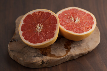 Fototapeta na wymiar Ripe grapefruit on wood board closeup