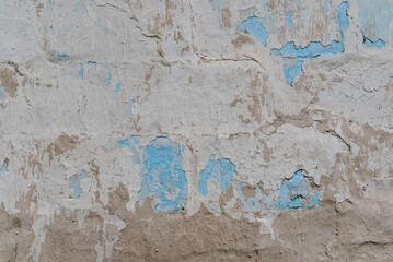 Weathered cracked plaster background. Damaged wall texture with peeling paint, shabby vintage rustic surface.