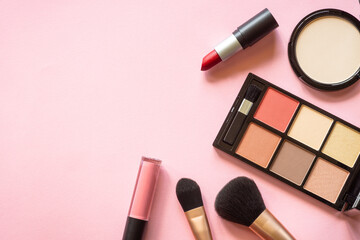 Makeup professional cosmetics on pink background. Flat lay image with copy space.