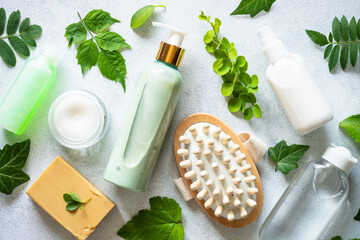 Fototapeta na wymiar Natural cosmetic concept. Skin care product, cream, soap, tonic, mask with green plants. Flat lay image.
