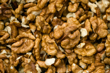 Selective focus. Peeled walnut kernels. Background from walnut kernels. Peeled walnuts.