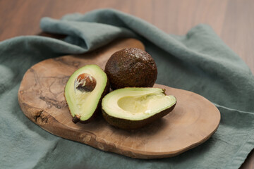 Ripe avocados on olive wood board