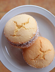 Top view of two Alfajores, traditional Latin American sweets served on a white plate