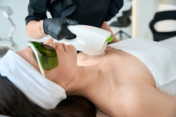 Beautiful lady on neck laser hair removal procedure