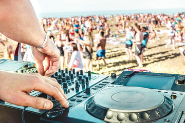 Detail of dj playing modern sound on cd usb player at spring break festival - Beach music party and...