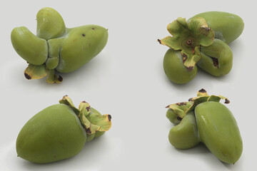 Four ugly and weird looking persimmons on white background