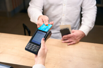 Guest paying for hotel room at reception desk