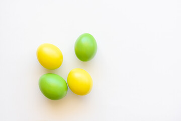 Easter eggs in yellow and green on a white background.