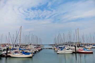 Fototapeta na wymiar Sailing boats in marina of Howth. Cloudy day in Howth, Dublin, Ireland. 