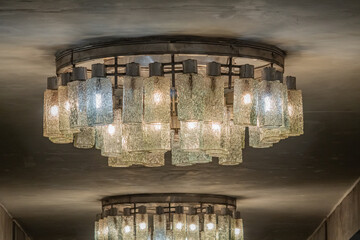 Old large Soviet glass chandelier in the style of modernism in the interior of the 1980s on Tarasa...