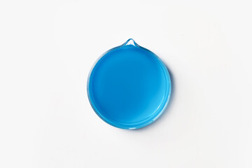 Crystallization cup for laboratory with blue, blue liquid. On a white, light background. View from above.