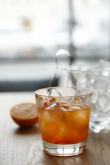 Refreshing bitter spritz drink served in a bar. Orange alcoholic beverage in a glass