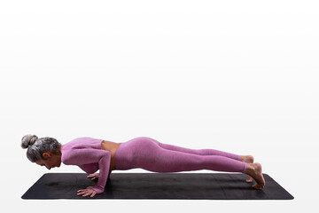 woman practicing yoga - four limed staff pose - chaturanga