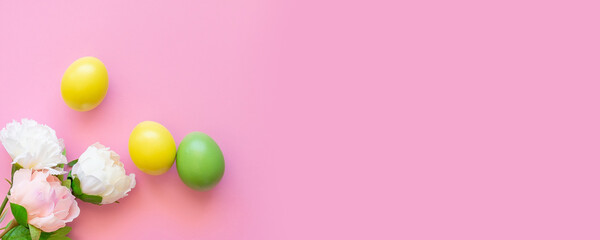Easter eggs in yellow and green on a pink background.