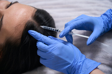 Lady doing cosmetic procedures for face, hair nutrition