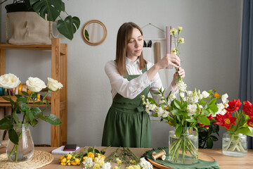 Woman arranging flowers in vase