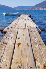 Fototapeta premium Old wooden pier on coast of Bay of Kotor, Tivat. Montenegro