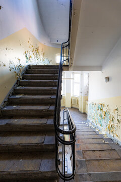 View of an old rectangular spiral staircase in an old abandoned building