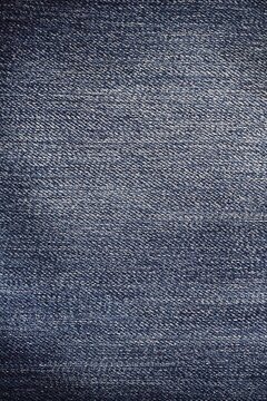 Abstract textured vertical background of fabric. Dark color material, copy space.
