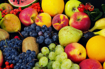 A variety of fruits on a wooden table.