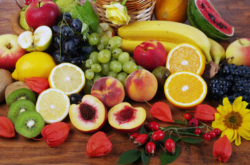 A variety of fruits on a wooden table.