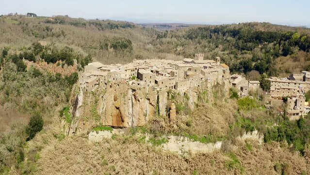 Aerial view of old town of Calcata, in the Province of Viterbo, Lazio, Italy. The town overlooking the valley of Treja. All houses have traditional red tiled roofs in the historical centre of Calcata.