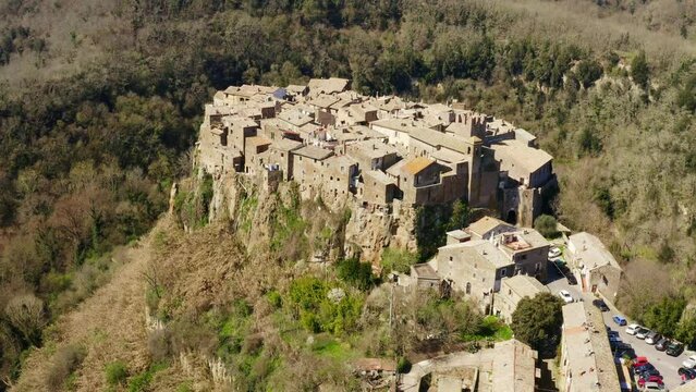 Aerial view of old town of Calcata, in the Province of Viterbo, Lazio, Italy. The town overlooking the valley of Treja. All houses have traditional red tiled roofs in the historical centre of Calcata.