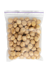 heap of roasted peeled hazelnuts isolated on white background, top view, concept of healthy breakfast, vegan food, dried nuts in transparent package