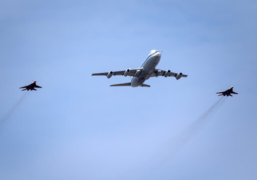 MOSCOW, RUSSIA - MAY 7, 2022: Avia parade in Moscow. MiG-29 and strategic bomber and missile platform IL-86 in the sky on parade of Victory in World War II in Moscow, Russia