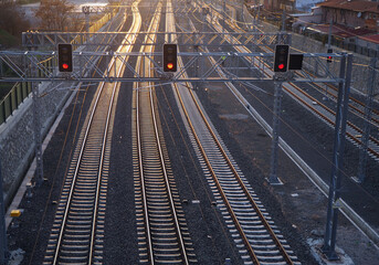 Complexe railroad at sunset. Signaling lamps on train tracks