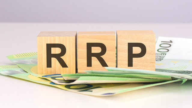 rrp - text on wood cubes with euro bills