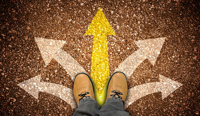 Yellow leather shoes and five chalky arrows on ground - choice concept