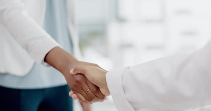 Business people, handshake and partnership for b2b, meeting or trust in teamwork at the office. Colleagues shaking hands in unity, deal or agreement for greeting, welcome or introduction at workplace