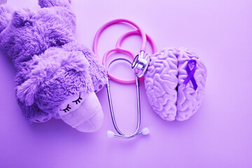 Purple day. Epilepsy awareness day. Toy bear with purple ribbon.