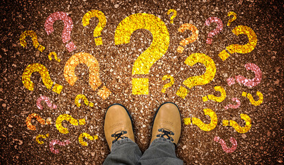 Yellow leather shoes and many colorful question marks - doubt concept