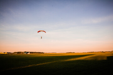 paraglider in the sunset - yellow field blue sky golden hour - Poland - Lower Silesia