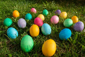 Fototapeta na wymiar Happy Easter. Easter eggs on the grass on a sunny spring day - Easter decoration, banner, panorama, background with space for text.