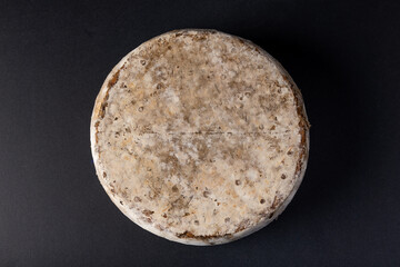Tome de Savoie, French cheese isolated on black background
